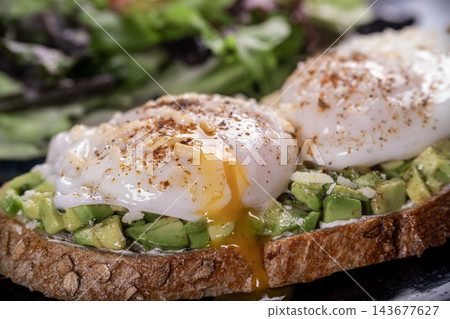 Sourdough Toast with Avocado and Poached Egg. Sourdough Toast with Avocado and Poached Egg. 143677627