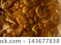Autumn Apple Jam Texture with Slices in Warm Golden Sunlight 143677838