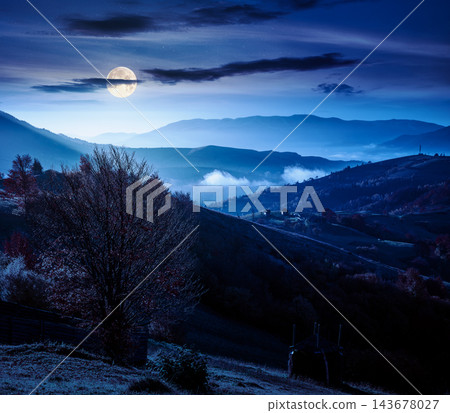 mountainous countryside landscape at night. full moon over dramatic sky above the distant valley. colorful fields and trees on the hill. mysterious nature landscape of Carpathians mountainous countryside landscape at night. full moon over dramatic sky above the distant valley. colorful fields and trees on the hill. mysterious nature landscape of Carpathians 143678027