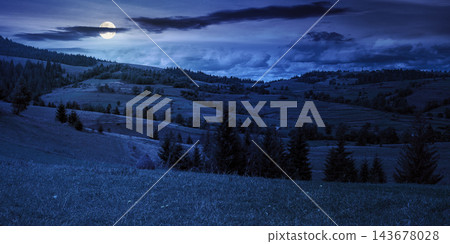 rural fields on rolling hills at night. full moon over green countryside scenery in early autumn. beautiful mountain landscape. backdrop for fiction art or mystery concept rural fields on rolling hills at night. full moon over green countryside scenery in early autumn. beautiful mountain landscape. backdrop for fiction art or mystery concept 143678028
