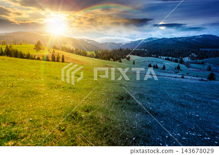 panoramic view of countryside of Ukraine. day meet night. sun and moon over wonderful springtime landscape in Carpathian mountains. grassy field and rolling hills. beautiful rural scenery 143678029
