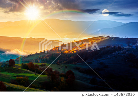 mountainous countryside landscape. day meet night. sun and moon on epic sky above the distant valley. colorful fields and trees on the hill. beautiful nature landscape of Carpathians mountainous countryside landscape. day meet night. sun and moon on epic sky above the distant valley. colorful fields and trees on the hill. beautiful nature landscape of Carpathians 143678030