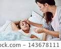 Mother, girl child and sick in bedroom with hand for check on fever, parent with healthcare for daughter. Mom, kid and medical care in home for FLiRT Covid, support or help for virus with headache 143678111