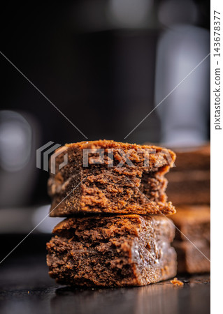 Close-Up Stack Of Chewy Chocolate Brownies With Crumbly Texture On Dark Surface Close-Up Stack Of Chewy Chocolate Brownies With Crumbly Texture On Dark Surface 143678377