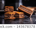 Close-Up Stack Of Chewy Chocolate Brownies With Crumbly Texture On Dark Surface 143678378