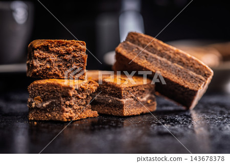 Close-Up Stack Of Chewy Chocolate Brownies With Crumbly Texture On Dark Surface Close-Up Stack Of Chewy Chocolate Brownies With Crumbly Texture On Dark Surface 143678378