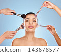 Application, hands and makeup brush with woman, portrait and cosmetics or aesthetics in studio. Beauty, model girl and beautician with wellness for foundation and makeover for skin by blue background 143678577