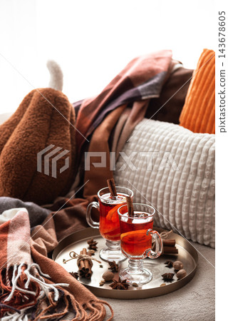 Cozy autumn setup with hot spiced tea and cinnamon on tray Cozy autumn setup with hot spiced tea and cinnamon on tray 143678605