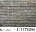 Close-up of beige woven fabric texture with tight plain weave and visible cream and tan threads, full frame textile background 143678690