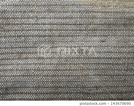 Close-up of beige woven fabric texture with tight plain weave and visible cream and tan threads, full frame textile background Close-up of beige woven fabric texture with tight plain weave and visible cream and tan threads, full frame textile background 143678690