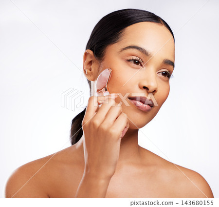 Detox, woman and rose quartz as face roller for beauty, anti aging or dermatology on white background. Female person, cosmetic product and skincare for results in studio backdrop for wellness or glow Detox, woman and rose quartz as face roller for beauty, anti aging or dermatology on white background. Female person, cosmetic product and skincare for results in studio backdrop for wellness or glow 143680155