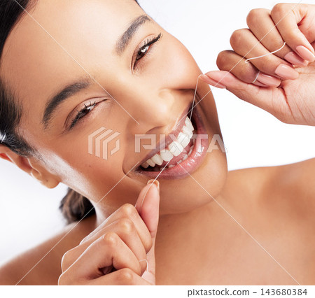 Studio, floss and woman in portrait for dental, healthcare and food particles. female model, plaque removal and teeth product for wellness, oral hygiene and prevention of cavities by white background 143680384