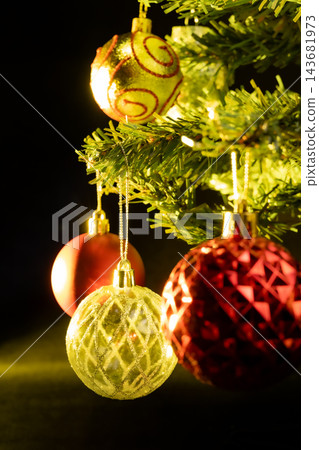 Christmas tree, a beautiful Christmas tree full of ornaments, dark abstract background, selective focus. 143681973