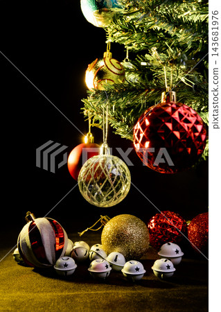 Christmas tree, a beautiful Christmas tree full of ornaments, dark abstract background, selective focus. Christmas tree, a beautiful Christmas tree full of ornaments, dark abstract background, selective focus. 143681976