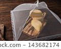 Semi-aged cheeses,beautiful and delicious semi-aged cheeses at various stages of maturation covered with fine cloth and resting on a rustic wooden table; selective focus. 143682174