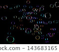 Soap Bubbles floating over black background isolated. Rainbow colorful air balls fly over many sizes. Shampoo bubbles sphere form shiny glossy blowing transparent purity in group. 143683165