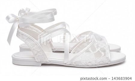 Elegant white lace wedding sandal with ribbon ankle tie closures footwear anniversary ceremony feminine delicate clothing romantic beautiful celebration ornamental occasion 143683904