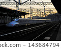 An N700 series Shinkansen departing the station before dawn. 143684794