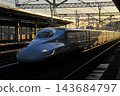 An N700 series Shinkansen passing through the station before dawn. 143684797