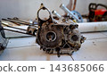 Disassembled Motorcycle Crankcase and Piston Assembly 143685066
