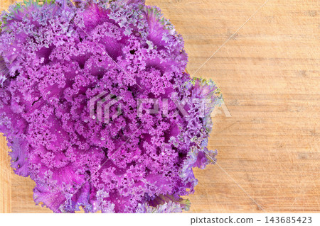 Purple Kale Leaves on Rustic Wooden Background Purple Kale Leaves on Rustic Wooden Background 143685423
