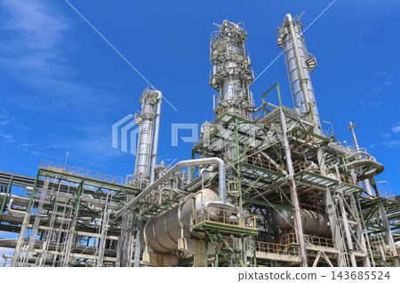 Industrial Oil Refinery with Petrochemical Towers Under Blue Sky Industrial Oil Refinery with Petrochemical Towers Under Blue Sky 143685524