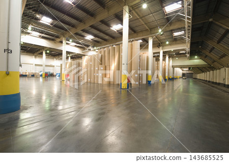 Industrial Warehouse Interior with Paper Rolls and Polished Concrete Floor 143685525