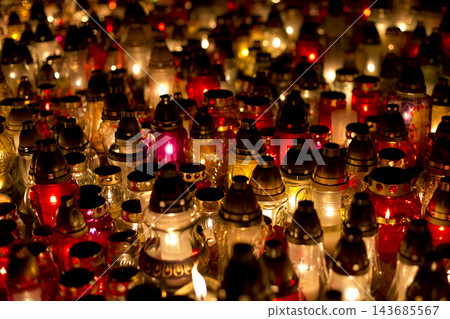 Lit memorial candles at a cemetery Lit memorial candles at a cemetery 143685567