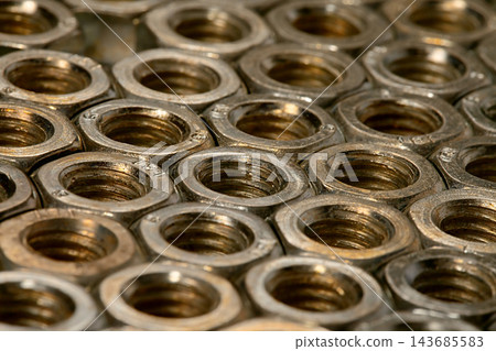Metal Hex Nuts Close-Up Industrial Hardware Background Metal Hex Nuts Close-Up Industrial Hardware Background 143685583