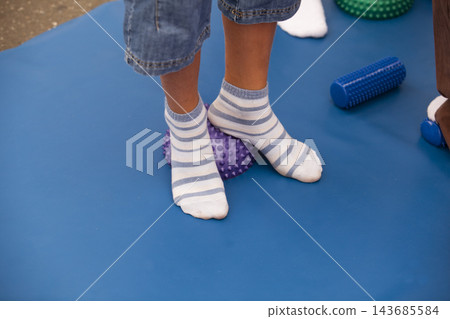 Physical Therapy Balance Exercise with Child Feet on Sensory Pad Physical Therapy Balance Exercise with Child Feet on Sensory Pad 143685584