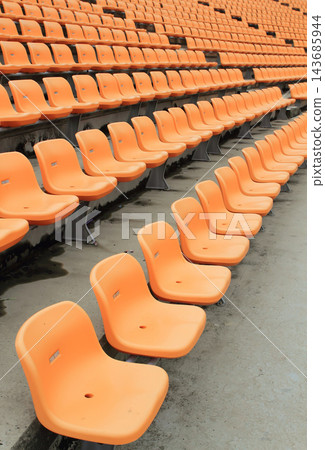Empty Orange Stadium Seats in Repeating Arena Rows 143685944