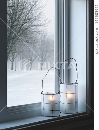 Winter Window with Glowing Candle Lanterns and Snowy Trees Winter Window with Glowing Candle Lanterns and Snowy Trees 143685965