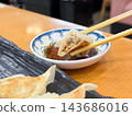 Dumplings eaten with dipping sauce. Close-up of the cross-section. 143686016