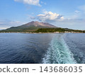 A view of Sakurajima, a volcano in Kagoshima Prefecture, from the sea. Smoke rises into the clear sky. 143686035
