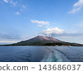 A view of Sakurajima, a volcano in Kagoshima Prefecture, from the sea. Smoke rises into the clear sky. 143686037