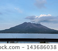 A view of Sakurajima, a volcano in Kagoshima Prefecture, from the sea. Smoke rises into the clear sky. 143686038
