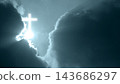 Glowing cross shape formed by light breaking through dramatic dark storm clouds in the sky, symbolizing faith, religion, hope, and divine grace. Concept of Christian 143686297