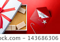 Christmas gift box open on a red background with a card reading Merry Christmas, candy cane and festive decorations. Concept of Merry Christmas 143686306