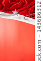 Christmas background with Santa hat, silver star ornament, and candy cane on vibrant coral backdrop with copy space. Concept of Merry Christmas 143686312