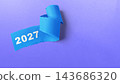 Blue torn paper with the year 2027 written on it, isolated on a purple background. Concept of Happy New Year 143686320