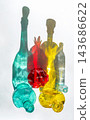 Vertical Composition of Colorful Glass Bottles and Pomegranate 143686622