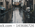 A reflection in a residential alley, glistening with rain. 143686726