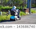 Elderly people traveling on country roads using mobility scooters 143686740