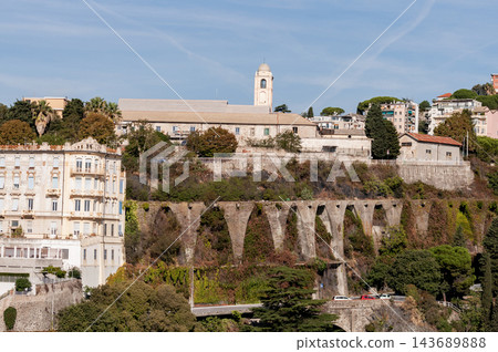 Savona, Italy with port and hillside buildings, panoramic coastal view Savona, Italy with port and hillside buildings, panoramic coastal view 143689888
