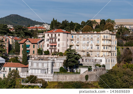 Savona, Italy with port and hillside buildings, panoramic coastal view Savona, Italy with port and hillside buildings, panoramic coastal view 143689889