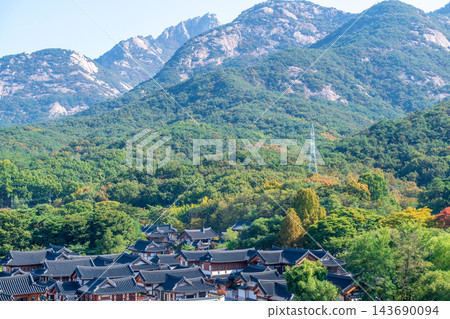 Traditional Korean Hanok Houses and Tiled Roofs against Bukhansan Mountain in Eunpyeong Hanok Village, Seoul Traditional Korean Hanok Houses and Tiled Roofs against Bukhansan Mountain in Eunpyeong Hanok Village, Seoul 143690094