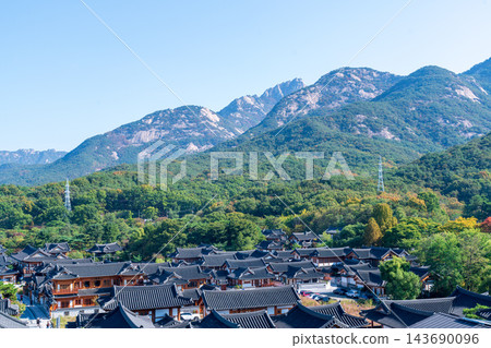 Traditional Korean Hanok Houses and Tiled Roofs against Bukhansan Mountain in Eunpyeong Hanok Village, Seoul Traditional Korean Hanok Houses and Tiled Roofs against Bukhansan Mountain in Eunpyeong Hanok Village, Seoul 143690096