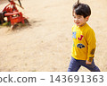 A boy playing energetically in the park 143691363