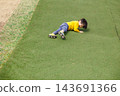 A boy playing energetically in the park 143691366