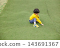 A boy playing energetically in the park 143691367